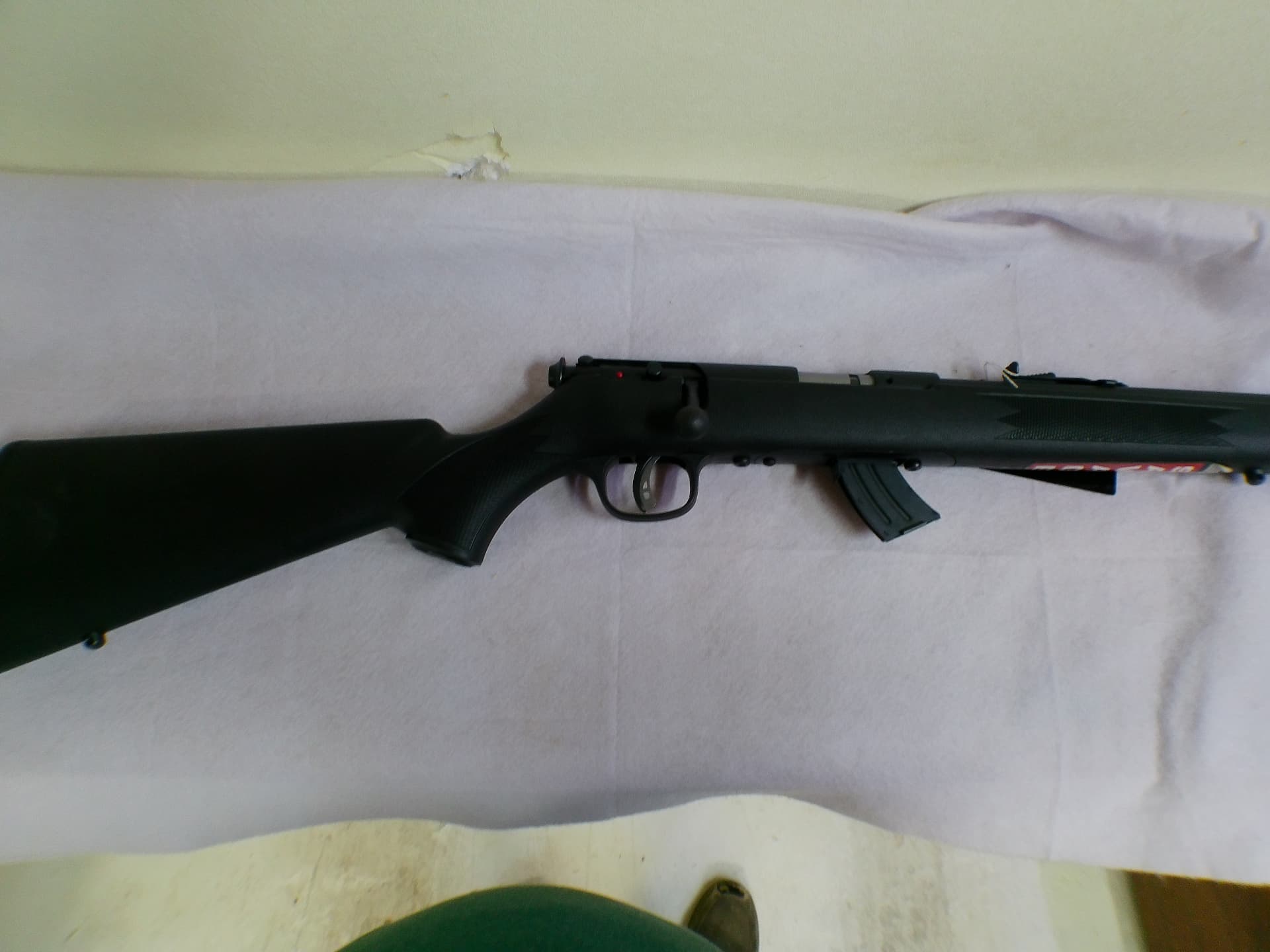 New bolt-action rimfire rifle with its purchase tag still attached